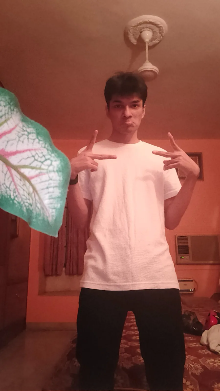 Portrait in a white shirt making peace signs